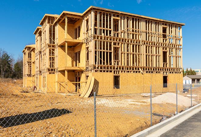 a temporary chain link fence in front of a building under construction, ensuring public safety in Burns, TN